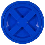 The Gamma2 GAMMA Seal Lid, shown in blue with a cross-shaped handle, is made from BPA-free HDPE plastic. It displays open and close instructions and fits buckets securely to create an airtight seal.