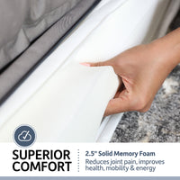 A hand presses into a white 2.5-inch solid memory foam mattress, showcasing its superior comfort, joint pain reduction, and enhanced health benefits, similar to the PetFusion Ultimate Dog Bed With Memory Foam for anxiety support. A partial gray sheet covers the foam.