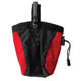 The Chuckit! Treat Tote, in black and red, is crafted from durable packcloth. It features a drawstring closure and a convenient clip for easy attachment, designed to securely hold treats during your adventures.