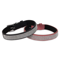 Two Petmate Bling Leather Custom Fit Collars, one in black and the other in red, feature sparkling rhinestones and metal buckle closures. They are stylishly arranged with a slight overlap on a pristine white background.