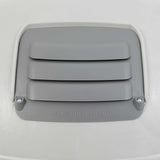 The Petmate Husky Shelter Vent Kit features a gray cover with horizontal slats, DO NOT LIFT BY VENT embossed below, and is secured with two screws on a smooth, light-colored surface to ensure your pets safety.