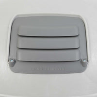 The Petmate Husky Shelter Vent Kit features a gray cover with horizontal slats, DO NOT LIFT BY VENT embossed below, and is secured with two screws on a smooth, light-colored surface to ensure your pets safety.