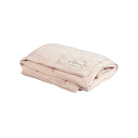 A folded beige PetFusion Premium Cat and Dog Cooling Blanket, featuring a subtle pattern and a visible tag with the Petfusion logo and text about its cooling technology for optimal temperature control, lies soft and neatly arranged against a plain white background.