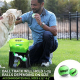 A person kneels on grass, playing fetch with a golden retriever using the Hyper Pet GoDogGo Fetch Machine Dog Ball Launcher by Hyperpet. The session features a ball launcher with green tennis balls, highlighting its impressive capacity and size compatibility for endless fun.