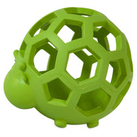 The JW Hol-ee Cow Dog Toy by JW is a green, hollow geometric sphere with hexagonal cutouts, resembling a turtle shell. Ideal for small dogs to chew on, it includes a small turtle head and feet for added charm.