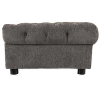 The La-Z-Boy Newton Sofa Dog Bed in dark gray features a tufted button design with sleek black cylindrical legs, set against a crisp white background.