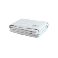 The PetFusion Premium Cat and Dog Cooling Blanket is a neatly folded, light gray blanket featuring advanced cooling technology. It boasts visible stitching, with a small Petfusion logo embroidered in one corner, offering softness and plushness for comfort while maintaining optimal temperature.