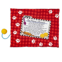 Introducing the FAT CAT Big Mamas Makin Biscuits Boogie Mat by Fatcat—a red checkered pet food mat with white paw prints, an attached Makin Biscuits recipe card, and a yellow textured ball on a blue string for organic catnip fun!.