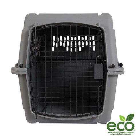 The Aspen Pet Traditional Kennel has a gray design with a black metal door and ample ventilation holes, making it ideal for travel. Made from 90% pre-consumer recycled plastic, its eco-friendly, featuring a green eco label at the bottom right corner.