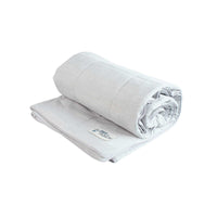 A sleek, light gray PetFusion Premium Cat and Dog Cooling Blanket with a soft texture. The rolled end of this plush cooling blanket ensures optimal comfort and warmth.