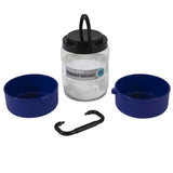 The Vittles Vault Travel-Trainer is a BPA-free pet travel container set featuring a clear cylindrical holder, two blue bowls, a black carabiner, and an airtight seal with a black lid and handle.