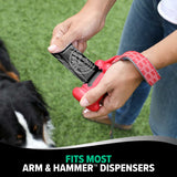 A person outdoors loads an Arm & Hammer MAX Blackout Dog Waste Bag with activated baking soda into a red dispenser, their dog at their side. Text reads, Fits Most Arm & Hammer™ Dispensers.
